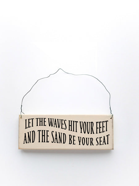 wood sign saying Let the Waves Hit Your Feet And The Sand Be You Seat