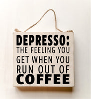 wood sign saying DEPRESSO: That Feeling You Get When You Run Out Of Coffee