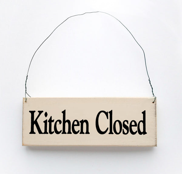 wood sign saying Kitchen Closed