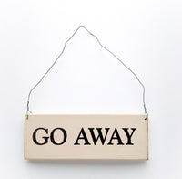 wood sign saying Go Away