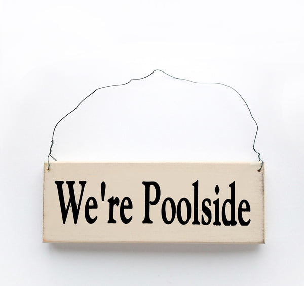 wood sign saying We're Poolside