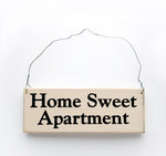 wood sign saying Home Sweet Apartment