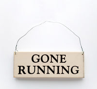 wood sign saying Gone Running