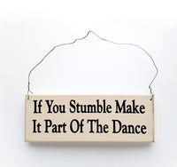 wood sign saying If You Stumble, Make It Part Of The Dance