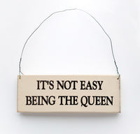 wood sign saying It's Not Easy Being the Queen