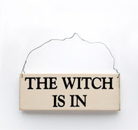 wood sign saying The Witch is In