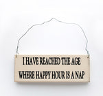 wood sign saying I Have Reached the Age Where happy Hour is a Nap