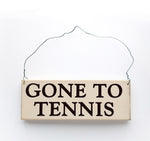 wood sign saying Gone to Tennis