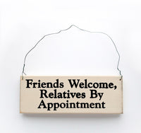 wood sign saying Friends Welcome, Relatives By Appointment
