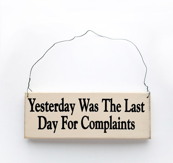 wood sign saying Yesterday Was the Last Day for Complaints