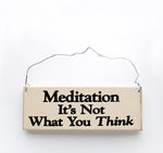 wood sign saying Meditation It's Not What You Think