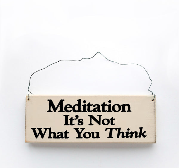 wood sign saying Meditation It's Not What You Think