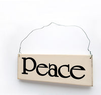 wood sign saying Peace