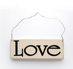wood sign saying Love