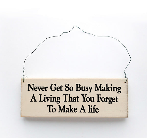 wood sign saying Never Get So Busy Making A Living That You Forget To Make A Life