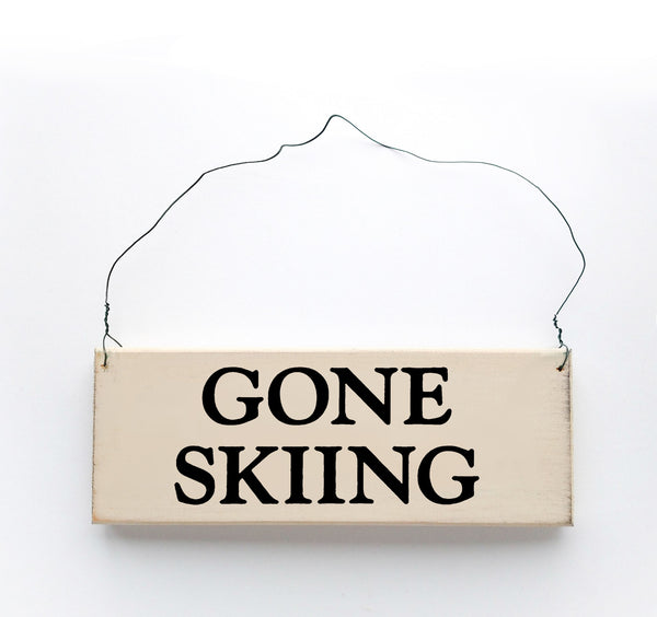wood sign saying Gone Skiing