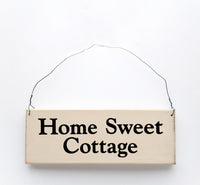 wood sign saying Home Sweet Cottage