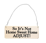 wood sign saying So It’s Not Home Sweet Home, Adjust!