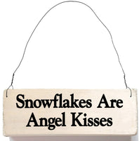wood sign saying Snowflakes Are Angel Kisses