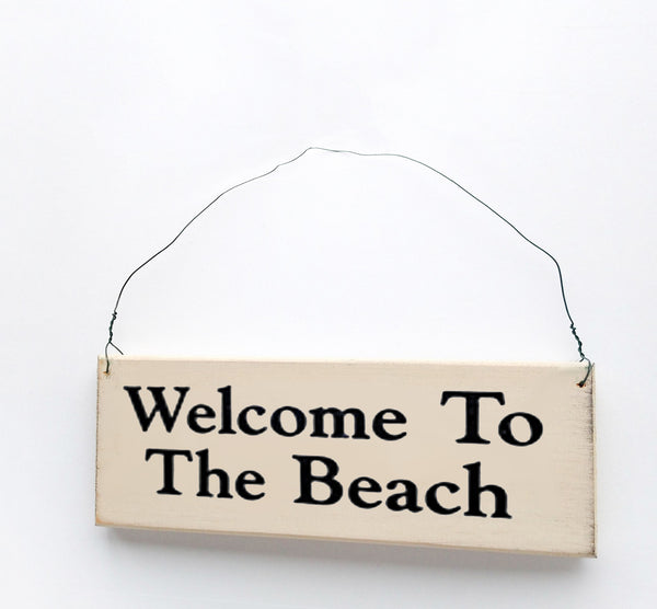 wood sign saying Welcome to the Beach