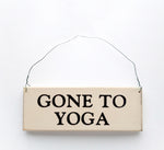 wood sign saying Gone To Yoga