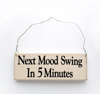 wood sign saying Next Mood swing In Five Minutes