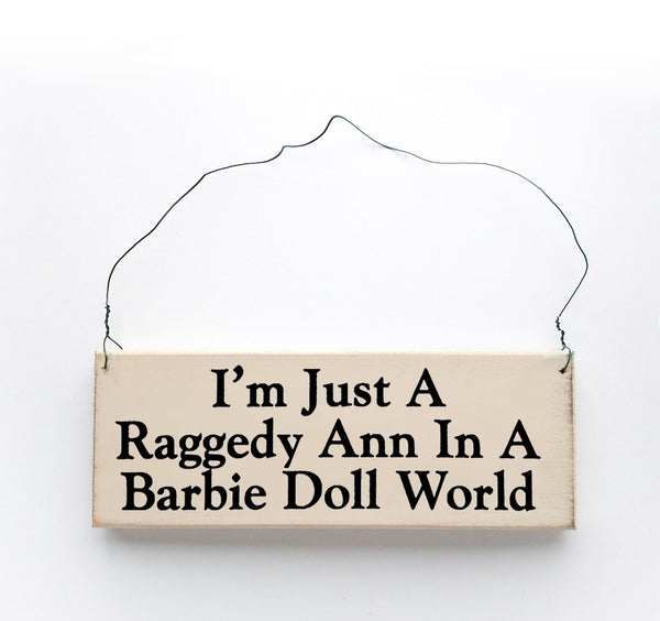 wood sign saying I'm Just A Raggedy Ann In A Barbie Doll World