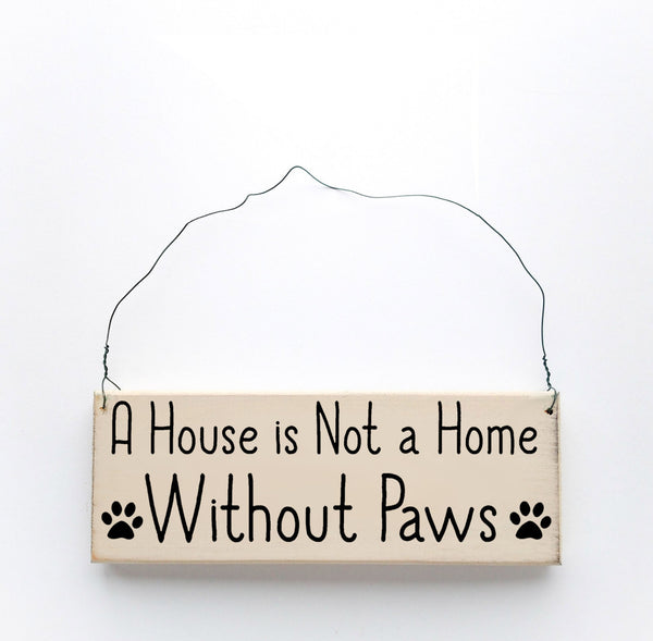 wood sign saying A House is Not A Home Without Paws