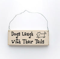wood sign saying Dogs Laugh With Their Tails