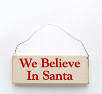 wood sign saying We Believe in Santa